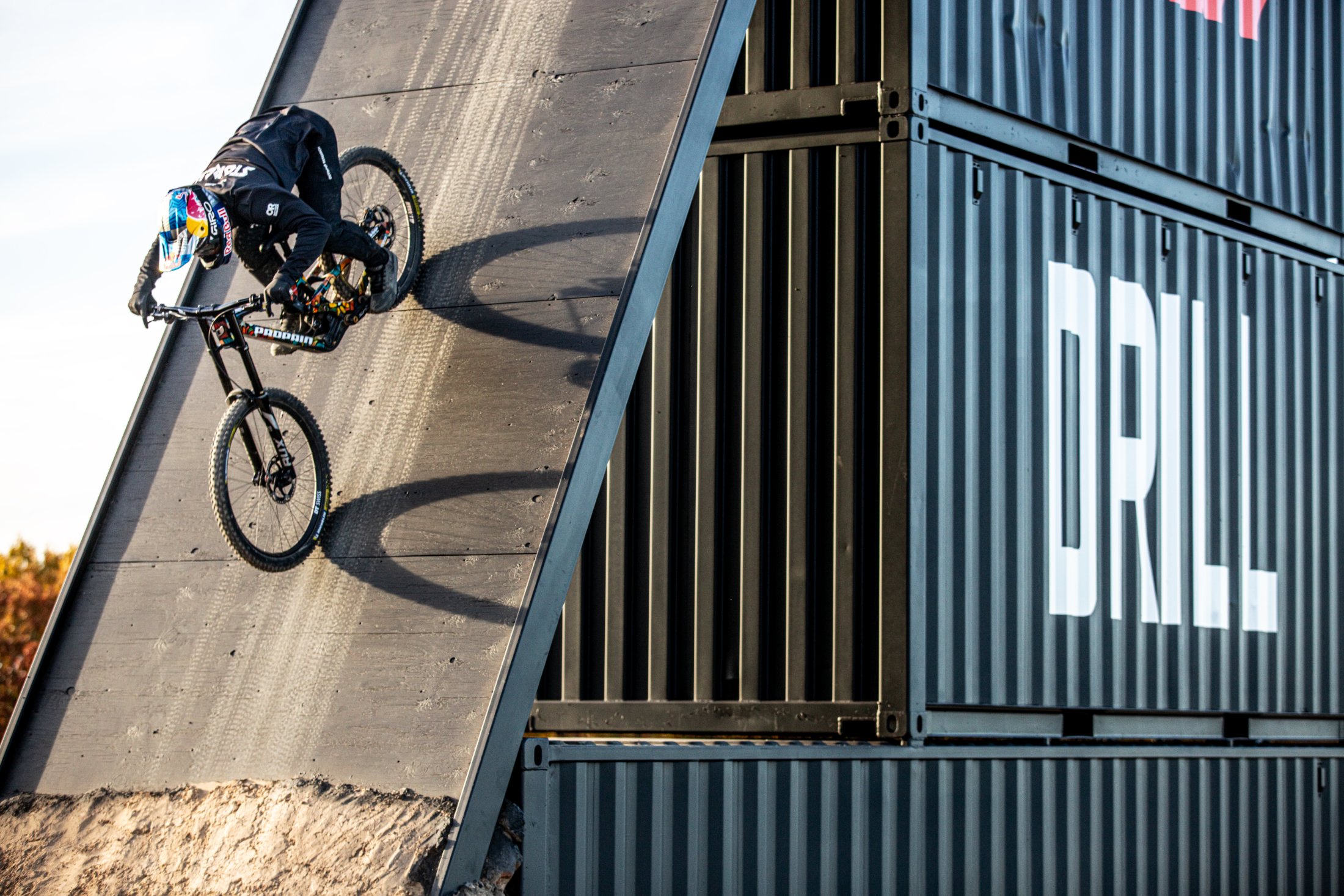 A Red Bull DRILL athlete riding the container drop