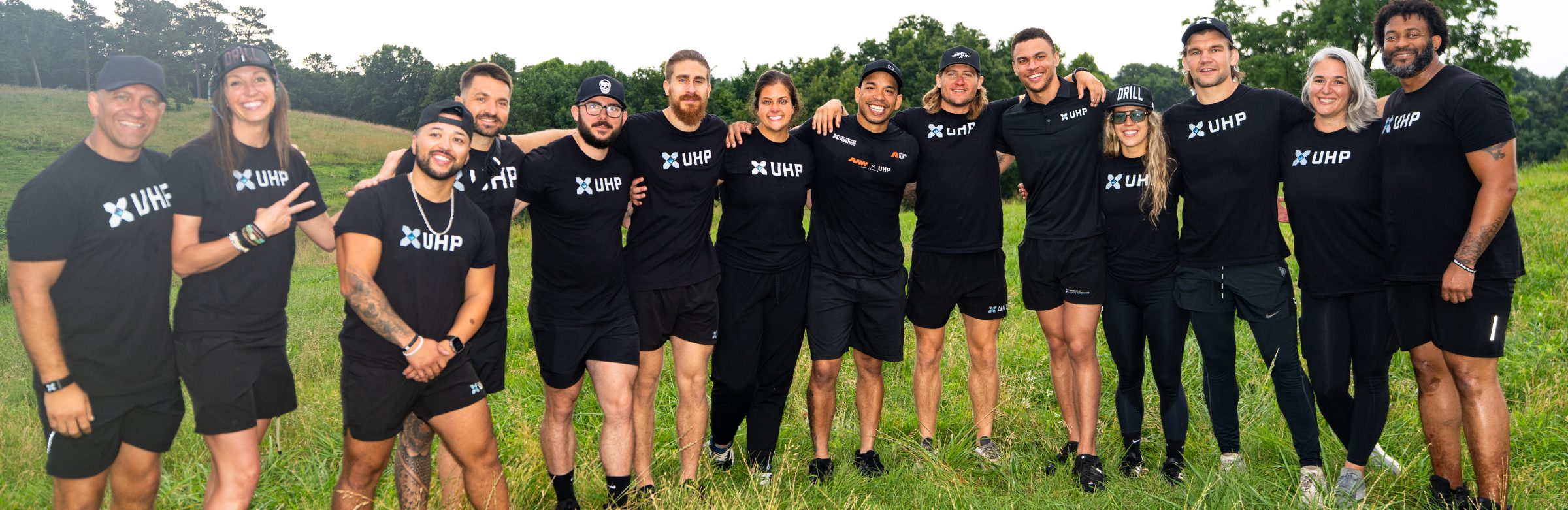 The UHP team standing together in a field on the campus